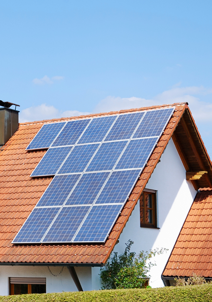 Home With Solar Panels On A Sunny Day
